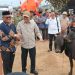 Menko Polkam Djamari Chaniago menyerahkan bantuan sapi meugang untuk warga di sela-sela peresmian 104 unit hunian tetap (huntap) bagi korban bencana hidrometeorologi di Gampong Kuala Cangkoi, Aceh Utara