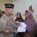 Bupati Aceh Utara, Ismail A Jalil (Ayahwa), menyerahkan bantuan Jaminan Hidup (Jadup) Kemensos RI