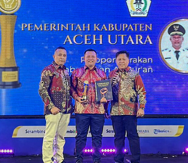 Bupati Aceh Utara, Ismail A. Jalil (Ayahwa), menerima penghargaan Serambi Award 2026 kategori "Pelopor Gerakan Membumikan Al-Qur'an" dari Pemred Serambi Indonesia Zainal Arifin M. Nur dan Pemimpin Perusahaan Firdaus D. di Gedung AAC Dayan Dawood, Banda Aceh